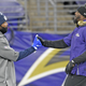 Maskless and with COVID-19, Dez Bryant (r.) greeted former teammates before Tuesday’s game with the Cowboys.